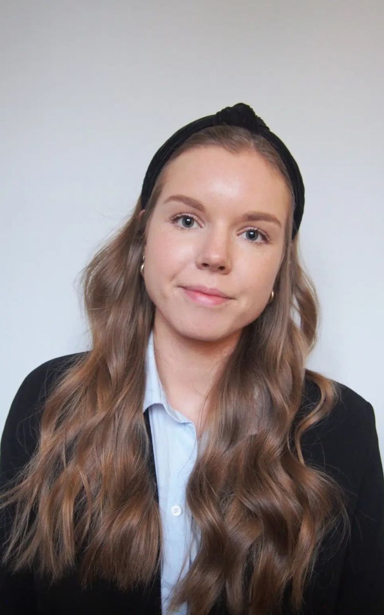 Kouluttaja Elisa Mustajärvi hymyilee kameralle.